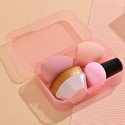 Set of makeup brushes in a pink case on a matching pink background