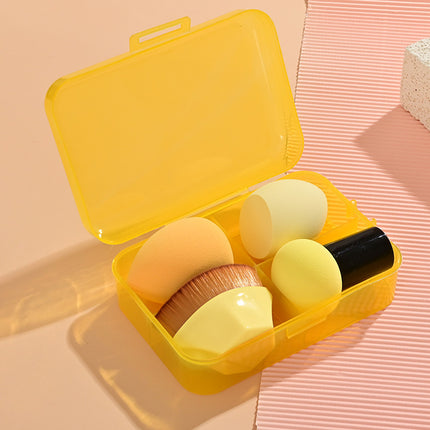Set of makeup brushes in a yellow case on a pink background