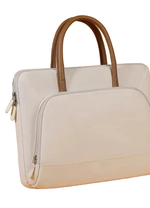 Light gray handbag with brown handle on a beige background