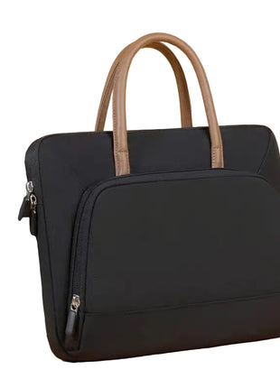 Black laptop bag with brown handles next to a silver laptop on a beige background