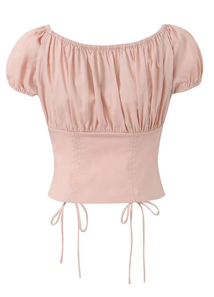 Short-sleeve pink cropped blouse with adjustable drawstring front and delicate lace detailing.