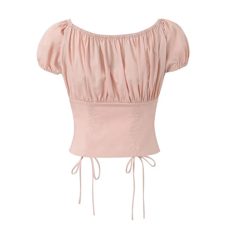 Short-sleeve pink cropped blouse with adjustable drawstring front and delicate lace detailing.