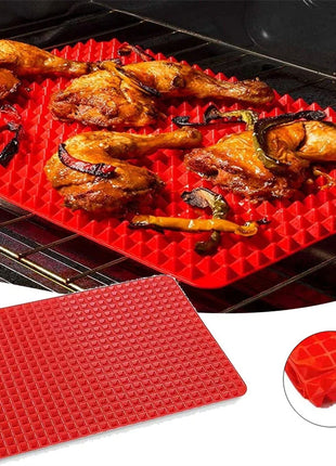 Red silicone mat with grilled chicken on a grill