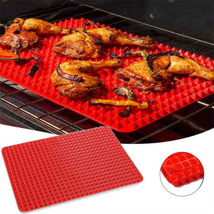 Red silicone mat with grilled chicken on a grill
