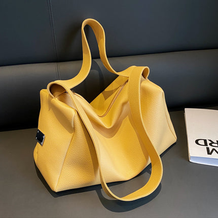 Yellow handbag on a dark surface with a blurred background