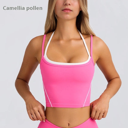 Woman wearing a pink sports bra and leggings on a light gray background