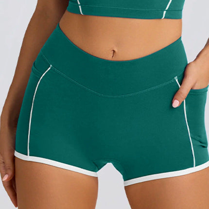 Green athletic shorts with white trim on a plain background