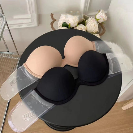 Black and beige bra on a black stand with flowers in the background