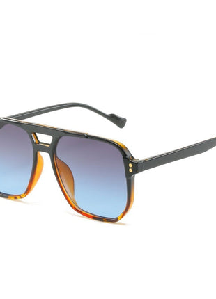 Sunglasses with a tortoiseshell frame and blue gradient lenses on a white background