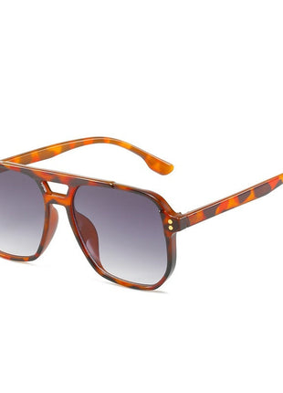 Sunglasses with leopard print frame and gray gradient lenses on a white background