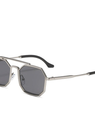 Sunglasses with metallic frame and dark lenses on a white background