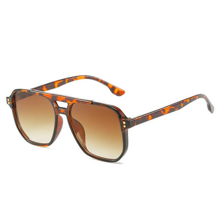 Sunglasses with tortoiseshell frame and brown gradient lenses on a white background