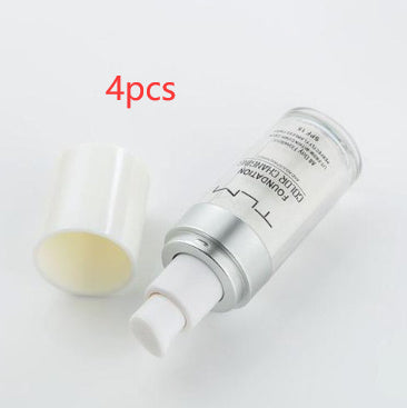 Four skincare bottles with a white background