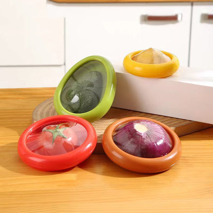 Four colorful kitchen containers with lids on a wooden surface.