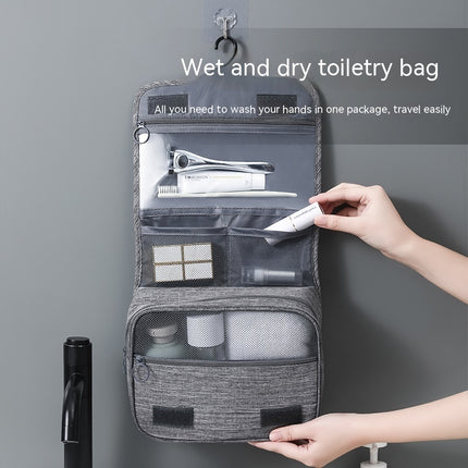 Gray toiletry bag with travel items on a gray background