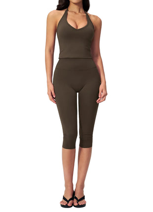 Two-piece women's activewear set with a fitted sleeveless top and stretchy capri pants for yoga and workouts.