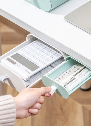 Desk organizer with compartments for a calculator and pens, held by a hand.