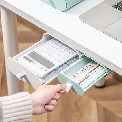 Desk organizer with compartments for a calculator and pens, held by a hand.