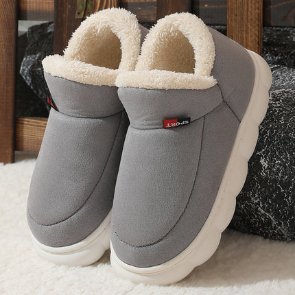 Gray slippers with white soles on a textured surface