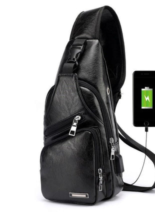 Black leather sling bag with USB charging port on a white background