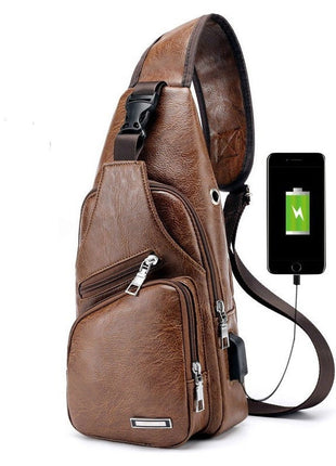 Brown leather sling bag with USB charging cable and smartphone on a white background