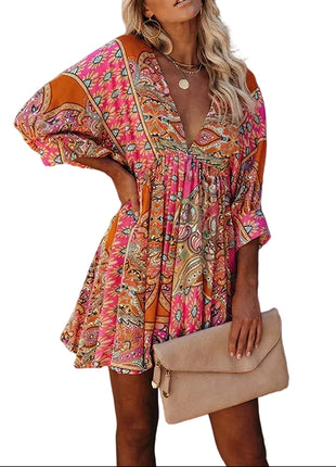 Woman wearing a colorful dress against a textured wall.