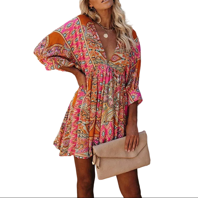 Woman wearing a colorful dress against a textured wall.