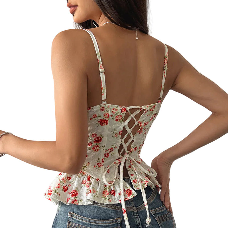 Woman wearing a floral top with lace-up back and blue jeans indoors blndl red