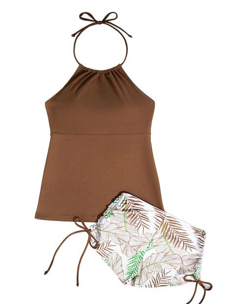 Brown halter top and leaf-patterned shorts on a white background with sunglasses and a leaf.