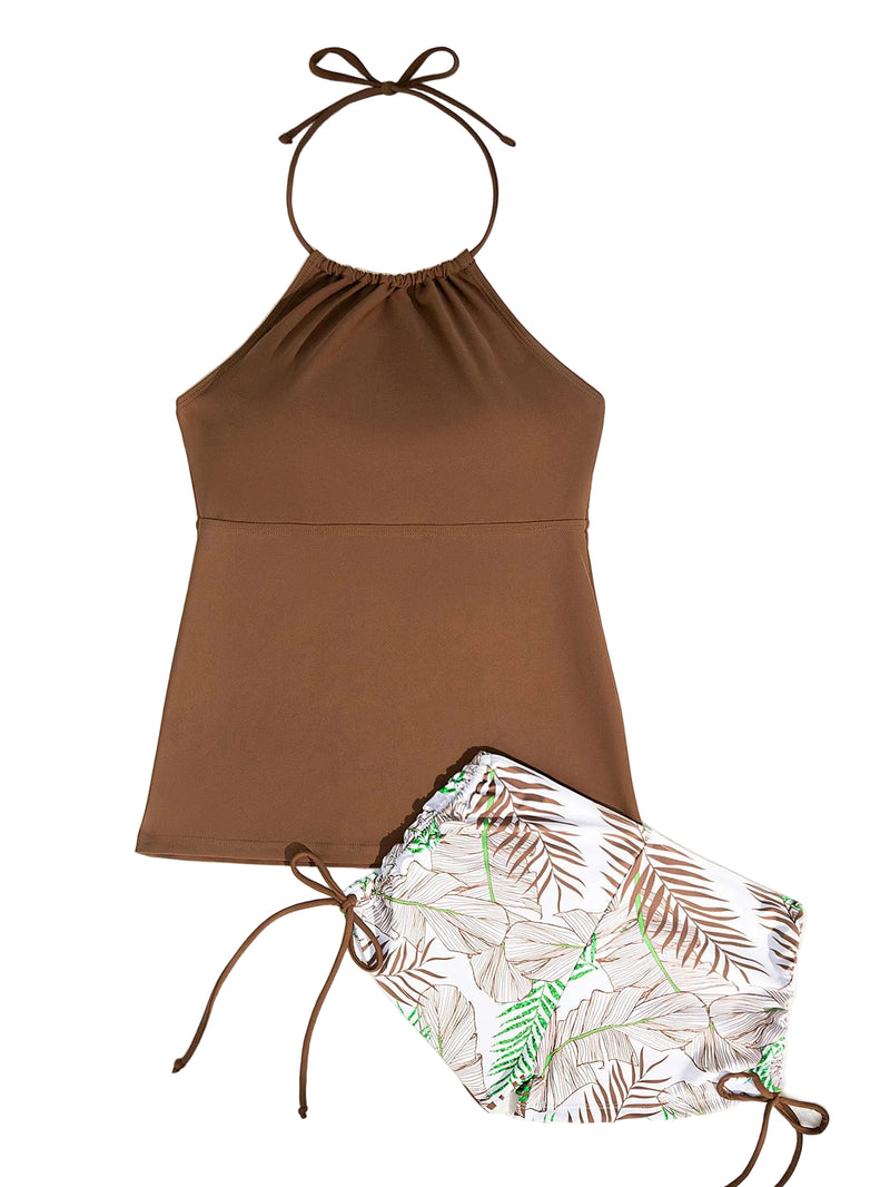 Brown halter top and leaf-patterned shorts on a white background with sunglasses and a leaf.
