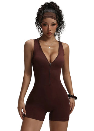 Woman wearing a brown bodysuit against a gray background