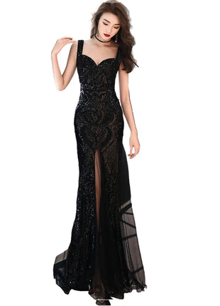 Woman in a black sequin evening gown against a modern interior background