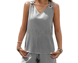 Woman wearing a black and white striped sleeveless top and shorts set outdoors.