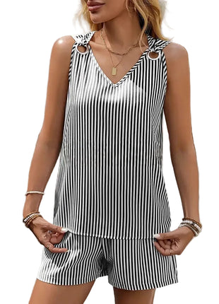 Woman wearing a black and white striped sleeveless top and shorts set outdoors.