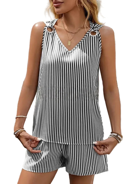Woman wearing a black and white striped sleeveless top and shorts set outdoors.