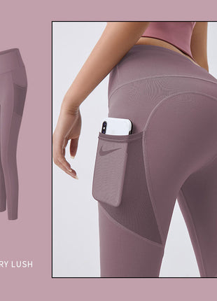 Berry lush leggings with a pocket feature on a light pink background