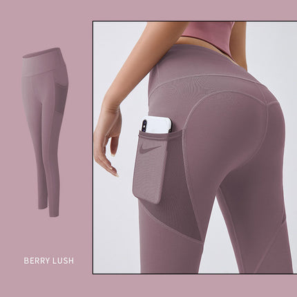 Berry lush leggings with a pocket feature on a light pink background