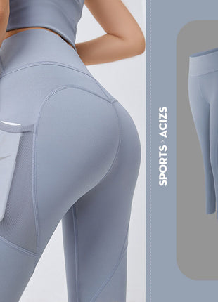 Light gray leggings with a pocket feature on a plain background