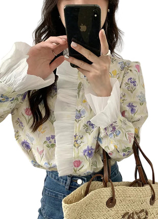 Women's elegant off-white turtleneck blouse with floral patchwork and ruffled bell sleeves, perfect for work and special occasions.