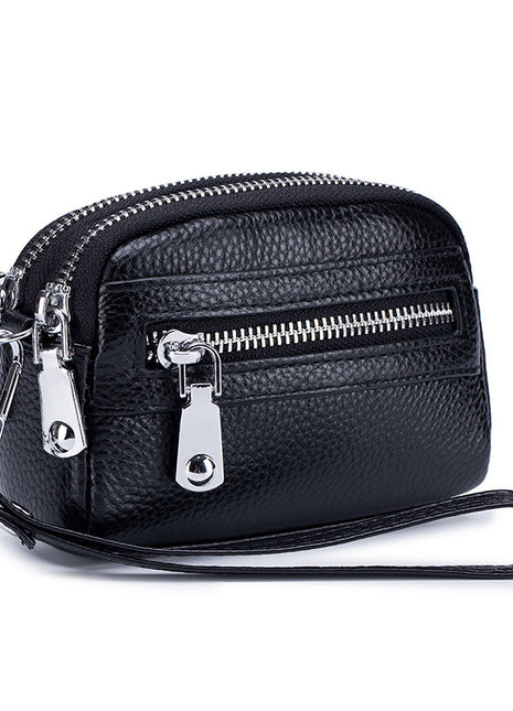 Women's first layer cowhide double zipper coin clutch made from genuine leather with compact storage design.