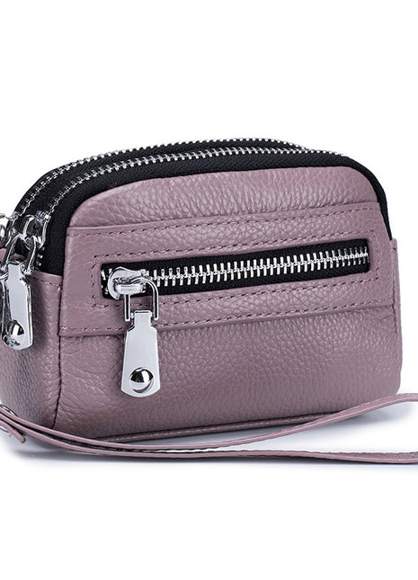 Women's first layer cowhide double zipper coin clutch made from genuine leather with compact storage design.