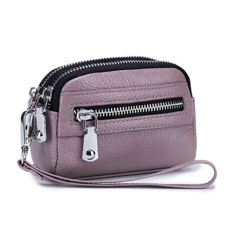 Women's first layer cowhide double zipper coin clutch made from genuine leather with compact storage design.