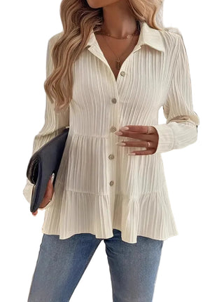 Women's minimalist long sleeve shirt paired with tailored trousers for a sophisticated office look.