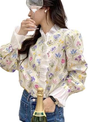 Women's patchwork floral shirt with flowing ruffled sleeves styled for office and smart-casual occasions.