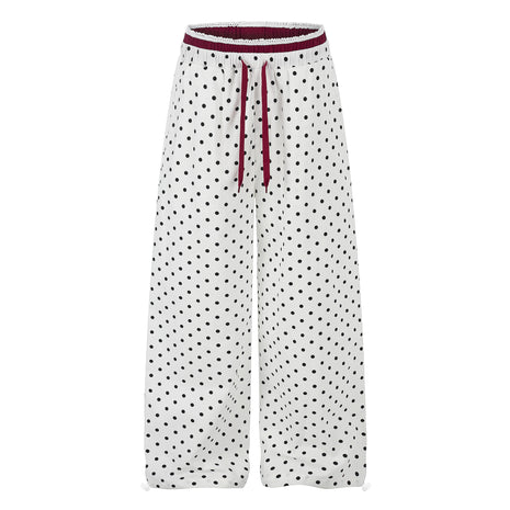 Women's ruffle-trimmed polka dot straight-leg pants featuring a mid-rise waist and cotton fabric.
