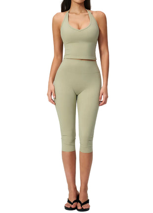 Women's sleeveless activewear set with matching capri pants for gym, yoga, travel, and athleisure styling.