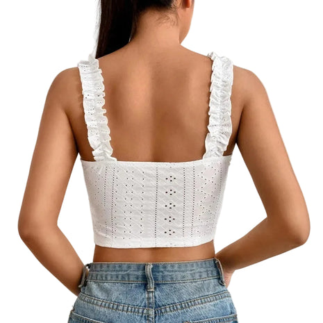 Women's slim-fit knitted camisole paired with high-waisted trousers for an elegant minimalist look.