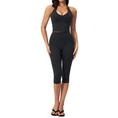 Women's slimming yoga outfit set featuring a sleeveless top and capri-length pants in soft nylon-spandex fabric.