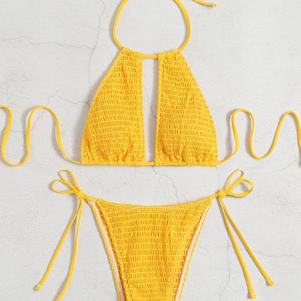 Yellow bikini set on a light gray background