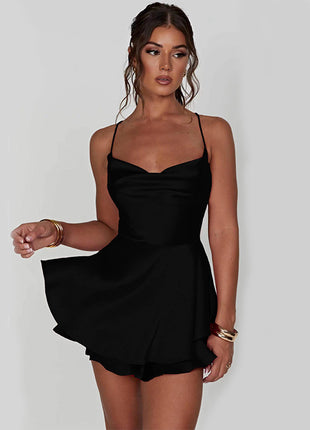 Woman wearing a black dress against a plain background